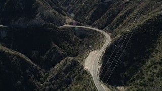 AX0009_019 - 5K aerial stock footage of a bend of a road through the San Gabriel Mountains, California