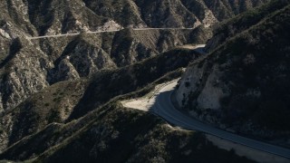 AX0009_021 - 5K aerial stock footage of tracking a motorcyclist on a road in the San Gabriel Mountains, California