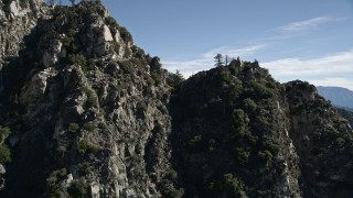 AX0009_032 - 5K aerial stock footage approach and fly over a rocky ridge in the San Gabriel Mountains, California