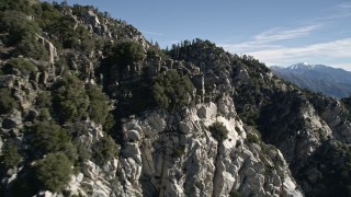 AX0009_033E - 5K aerial stock footage approach and fly over jagged and rocky slopes in the San Gabriel Mountains, California