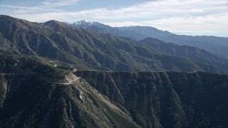 AX0009_036 - 5K aerial stock footage approach road on a mountain ridge in the San Gabriel Mountains, California