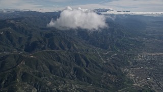 AX0009_071E - 5K aerial stock footage approach cloud over the San Bernardino Mountains of California