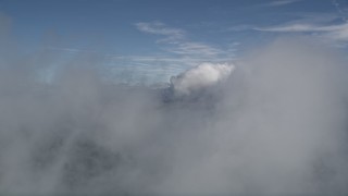 AX0009_079E - 5K aerial stock footage of flying through clouds over the San Bernardino Mountains, California