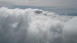 AX0009_091E - 5K stock footage aerial video fly over thick cloud cover over San Bernardino County, California