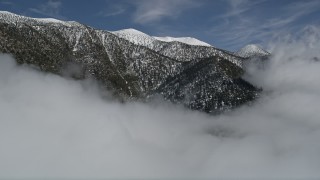 AX0009_113 - 5K aerial stock footage of approaching San Bernardino Mountains ridge with winter snow, California