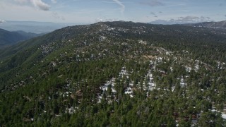 AX0009_137 - 5K aerial stock footage of patches of snow and evergreen forest in the San Bernardino Mountains, California