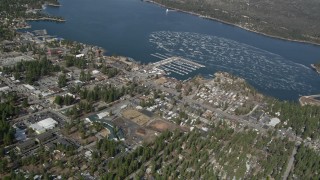 AX0009_138 - 5K aerial stock footage orbit a small lakeside town on Big Bear Lake in winter, California