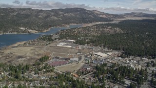 AX0009_139 - 5K aerial stock footage orbit lakeside shopping center in the small town of Big Bear Lake, California in winter