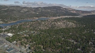 AX0009_140 - 5K aerial stock footage orbit the outskirts of the small town and the shore of Big Bear Lake in winter, California