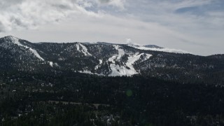 AX0009_142 - 5K aerial stock footage of Snow Summit ski slopes with winter snow, California
