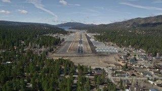 AX0009_143E - 5K aerial stock footage orbit and approach the runway at Big Bear City Airport, California