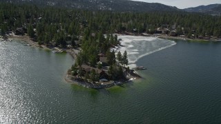 AX0010_018 - 5K aerial stock footage orbit lakeside homes by an ice patch at Big Bear Lake, California