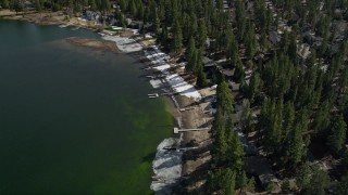 AX0010_037 - 5K aerial stock footage of bird's eye view of lakeside homes with winter snow at Big Bear Lake, California