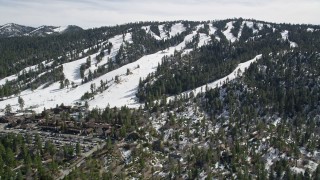 AX0010_039E - 5K aerial stock footage tilt to reveal and approach Snow Summit Ski Resort in winter, California