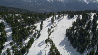 AX0010_042E - 5K aerial stock footage fly over skiers on the slopes of Snow Summit in winter, California