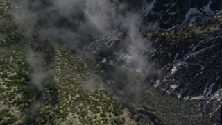 AX0010_069 - 5K aerial stock footage bird's eye view of snow in steep canyon in the San Jacinto Mountains, California
