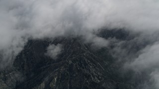 AX0010_075 - 5K aerial stock footage of bird's eye view of San Jacinto Mountains below layer of clouds, California
