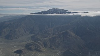 AX0010_083 - 5K aerial stock footage approach peak with cloud halo in the San Jacinto Mountains, California
