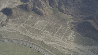AX0010_085 - 5K aerial stock footage of bird's eye view of a small wind farm in Whitewater, California
