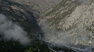AX0010_097 - 5K aerial stock footage orbit a canyon with light winter snow in the San Jacinto Mountains, California