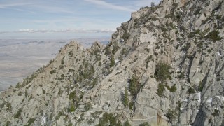 AX0010_098E - 5K aerial stock footage fly over mountain slopes with small patches of snow in the San Jacinto Mountains, California