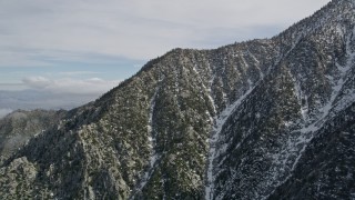 AX0010_100 - 5K aerial stock footage orbit peak with winter snow in the San Jacinto Mountains, California