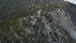 AX0010_111E - 5K aerial stock footage tilt to reveal and approach a tram station in the San Jacinto Mountains, California