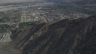AX0010_129 - 5K aerial stock footage orbit West Palm Springs suburban neighborhoods seen from the mountains, California