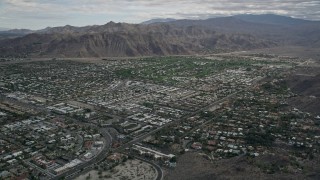 AX0010_130 - 5K aerial stock footage tilt to reveal and approach neighborhoods in West Palm Springs, California
