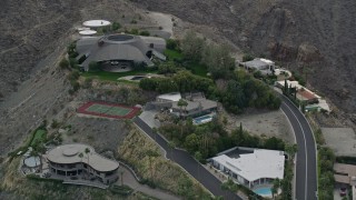 AX0010_136E - 5K aerial stock footage orbiting a group of hilltop mansions in West Palm Springs, California