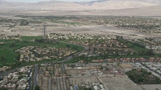 AX0010_139 - 5K aerial stock footage orbit suburban homes on golf course in South Palm Springs, California