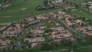AX0010_141 - 5K aerial stock footage orbiting apartment complex in South Palm Springs, California