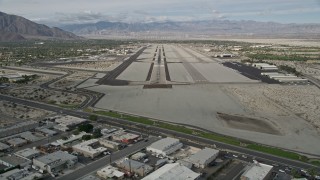 AX0010_144E - 5K aerial stock footage of approaching the runway at Palm Springs International Airport, California