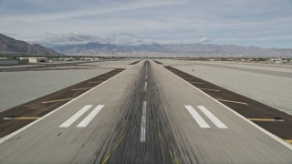 AX0010_146 - 5K aerial stock footage of ascending from the runway at Palm Springs International Airport, California