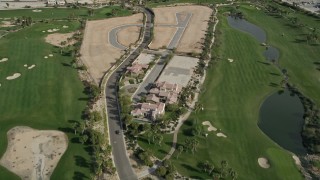 AX0010_148 - 5K aerial stock footage tilt to bird's eye view of a mansion on a golf course in East Palm Springs, California