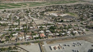 AX0010_149 - 5K aerial stock footage orbit suburban neighborhoods in Cathedral City, California