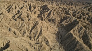 AX0011_004 - 5K aerial stock footage of flying over mountains in the Mojave Desert, California