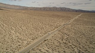 AX0011_006 - 5K stock footage aerial video orbit lonely desert highway in Joshua Tree National Park, California