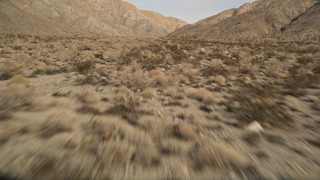 AX0011_017 - 5K aerial stock footage tilt to reveal desert mountains in Joshua Tree National Park, California
