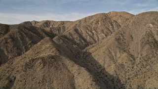 AX0011_021 - 5K aerial stock footage orbit desert mountain ridges in Joshua Tree National Park, California