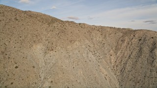 AX0011_022 - 5K aerial stock footage approach top of desert mountain ridge in Joshua Tree National Park, California