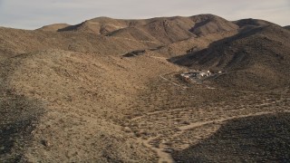 AX0011_046 - 5K aerial stock footage of isolated buildings in the desert, Joshua Tree National Park, California