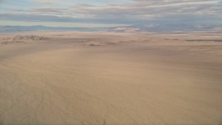 AX0011_069 - 5K aerial stock footage of desert plains and mountains, Mojave Desert, California