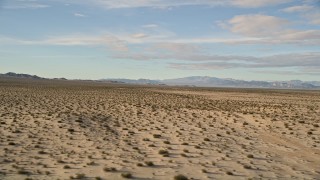 AX0011_073 - 5K stock footage aerial video fly low over desert vegetation while descending, Mojave Desert, California