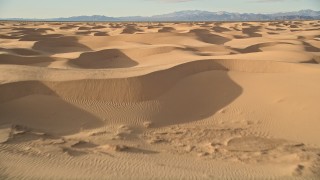 AX0012_013 - 5K aerial stock footage fly low over sand dunes, Kelso Dunes, Mojave Desert, California