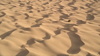 AX0012_017E - 5K aerial stock footage tilt down to bird's eye of sand dunes, Kelso Dunes, Mojave Desert, California