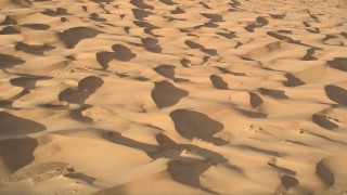 AX0012_021E - 5K aerial stock footage pan across sand dunes, Kelso Dunes, Mojave Desert, California