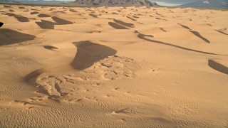 AX0012_031 - 5K aerial stock footage of flying over sand dunes, Kelso Dunes, Mojave Desert, California