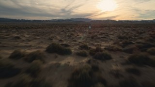 AX0012_041E - 5K stock footage aerial video fly low over desert plain, Mojave Desert, California