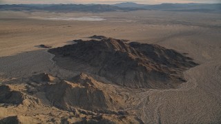 AX0012_049 - 5K stock footage aerial video fly over desert mountains, Mojave Desert, California, sunset